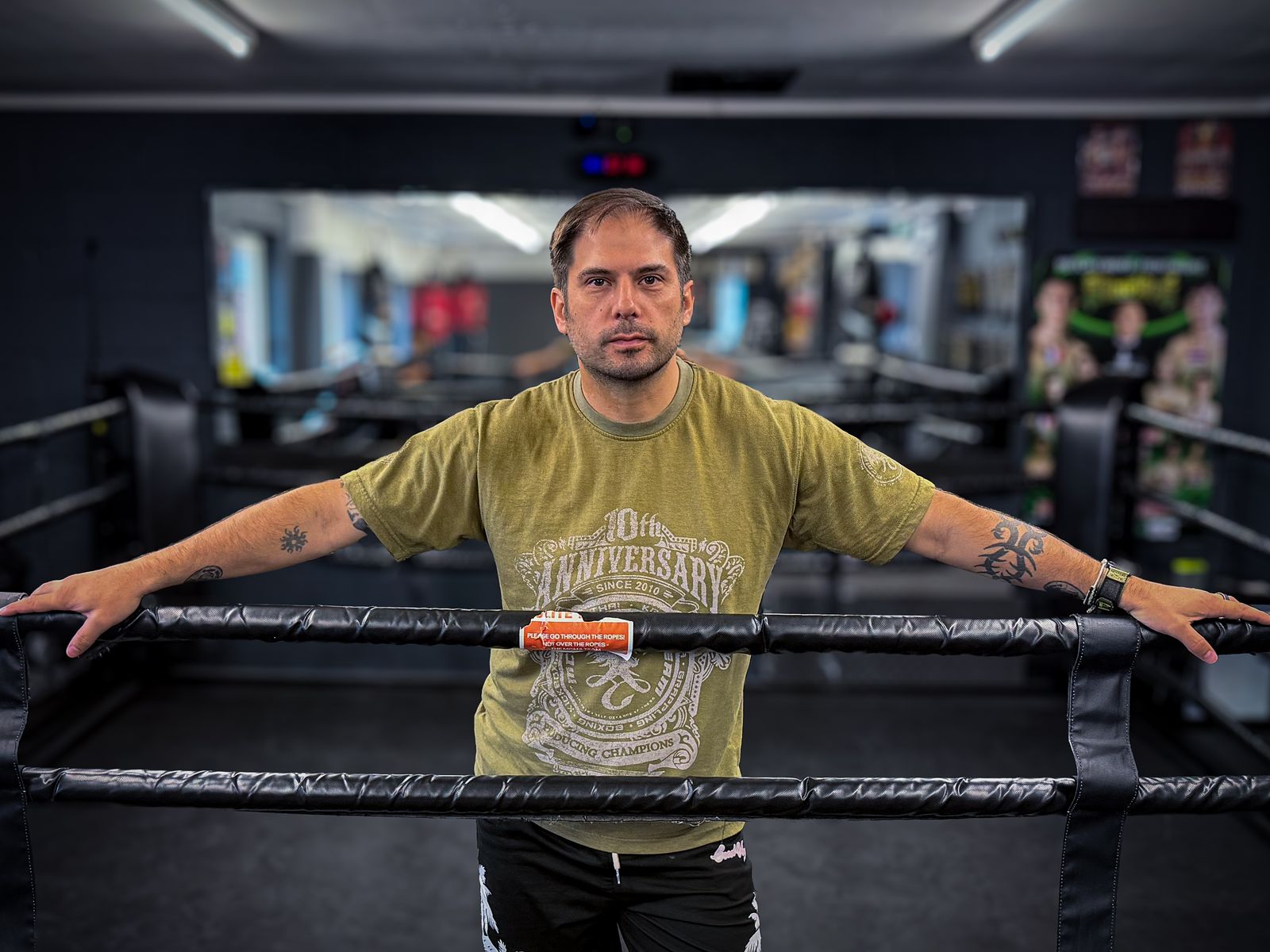 Paul Robinson leaning on the ropes of a boxing ring